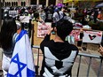 Pro-Israel (front) and pro-Palestinian students face off at an encampment on the campus of the University of California Los Angeles (UCLA), in Los Angeles on April 26, 2024.