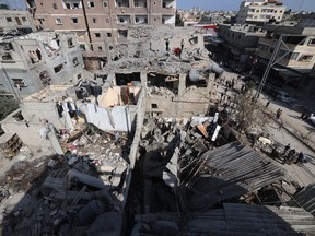Palestinians inspect the damage to buildings after Israeli bombardment in Rafah in the southern Gaza Strip, on April 29, 2024 amid the ongoing conflict between Israel and the Palestinian militant group Hamas.