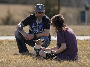 Dusty Farr talks with his transgender daughter in a park near Smithville, Mo., Sunday, Feb. 25, 2024.