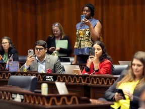 Democratic lawmakers record Arizona State Rep. Teresa Martinez, R, as she speaks from the House floor at the Capitol, Wednesday, April 10, 2024, in Phoenix. The Arizona Supreme Court ruled Tuesday that the state can enforce its long-dormant law criminalizing all abortions except when a mother's life is at stake.