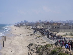 Displaced Palestinians try to walk back from central Gaza Strip to northern Gaza Strip , Sunday, April 14, 2024.