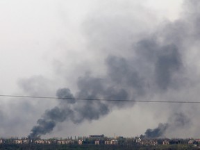 This photograph taken on April 11, 2024, near the town of Chasiv Yar, in Donetsk region, shows smoke rising from fires after bombing.