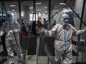 This file photo taken Jan. 25, 2020 shows medical staff members wearing protective clothing at the Wuhan Red Cross Hospital in Wuhan.