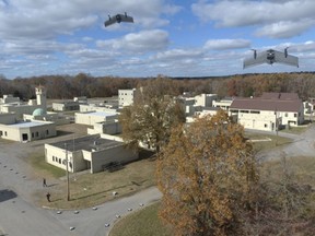 In this photo from the Defense Advanced Research Projects Agency, drones fly in a Defense Department urban warfare exercise at Fort Campbell, Tenn., in Nov., 2021.