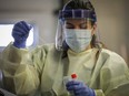 A nurse performs a test at a COVID-19 drive-through assessment centre during the peak of the pandemic.