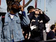 View shows people wearing special glasses to watch the eclipse