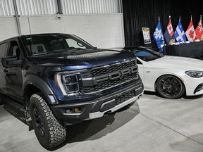 Two recovered stolen vehicles are shown ahead of a news conference in Montreal, Wednesday, April 3, 2024, on car theft in Quebec and Ontario.
