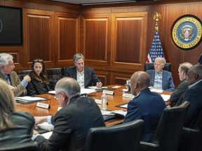 In this image released by the White House, President Joe Biden, along with members of his national security team, receive an update on an ongoing airborne attack on Israel from Iran, as they meet in the Situation Room of the White House in Washington, Saturday, April 13, 2024. From left to right, facing Biden are, Central Intelligence Agency director William Burns, Avril Haines, director of National Intelligence, Secretary of State Antony Blinken, and National Security adviser Jake Sullivan.