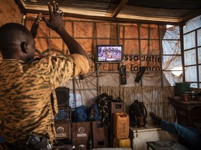 A soldier applauds the presidential inauguration of Junta leader Lt. Col. Paul Henri Sandaogo Damiba during his swearing-in ceremony broadcast on national television on Wednesday, Feb. 16, 2022 in Ouagadougou, Burkina Faso.