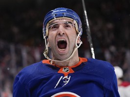 New York Islanders' Kyle Palmieri opens his mouth wide to yell in a closeup photo
