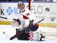 Charlie Lindgren looks over his shoulder in goal