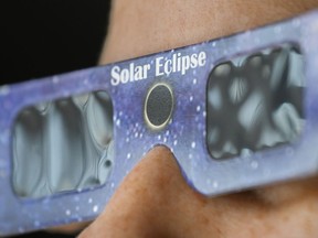 Total solar eclipses like the much anticipated one taking place next Monday are often thought of as visual experiences. A person wears a pair of NASA-approved solar eclipse glasses in Montreal, Tuesday, April 2, 2024.