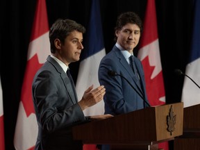 Prime Minister Justin Trudeau listens to French Prime Minister Gabriel Attal deliver his opening remarks during a joint news conference, Thursday, April 11, 2024 in Ottawa.