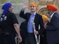 Prime Minister Justin Trudeau waves to the crowd after receiving a ceremonial sabre, called a "talwar" in the Punjabi language, as a special gift from the Ontario Sikhs and Gurudwara Council after speaking during Khalsa day celebrations at City Hall in Toronto, Sunday, April 28, 2024.