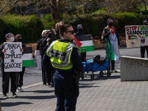 Pro-Palestinian protesters hold a demonstration during a visit by Prime Minister Justin Trudeau to the University of Victoria, in Saanich, B.C., on Friday, April 19, 2024. B.C.