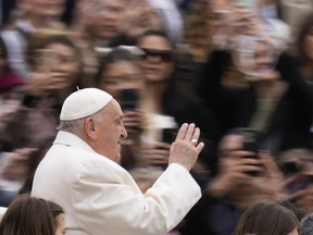 Pope Francis waves as he arrives for his weekly general audience in St. Peter's Square, at the Vatican, Wednesday, April 3, 2024.