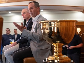 Captains Mike Weir, right, for the International Team, and Jim Furyk, for the U.S., are seen behind the Presidents Cup in the foreground.