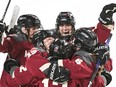 PWHL Montreal players embrace in celebration on the ice
