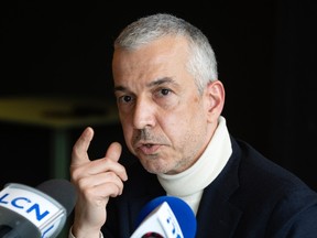 A man gestures during a press conference.