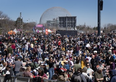 People gather to watch the total solar eclipse at Parc Jean Drapeau, in Montreal, Monday, April 8, 2024.