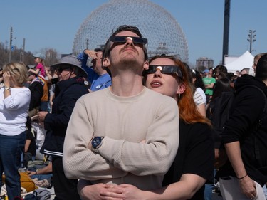 People watch the total solar eclipse at Parc Jean Drapeau, in Montreal, Monday, April 8, 2024.