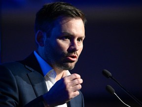 Parti Québécois Leader Paul St-Pierre Plamondon speaks at a podium