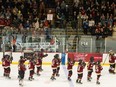 Montreal players raise their sticks in the air to salute the crowd following their last regular-season home game at the Verdun Auditorium on Wednesday. One fan is holding a sign that reads: "Play like a girl!"