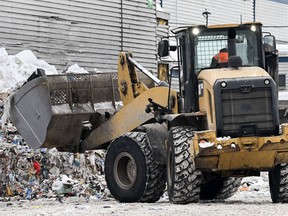 loader scoops up recyclable materials at a recycling facility in Montreal, Thursday, Feb. 2, 2023.
