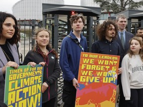 Swedish climate activist Greta Thunberg, second left, joins youths from Portugal during a demonstration outside the European Court of Human Rights Tuesday, April 9, 2024 in Strasbourg, eastern France.
