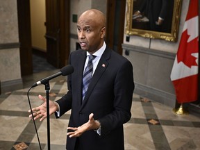 Minister of International Development Ahmed Hussen speaks in the foyer of the House of Commons before question period on Parliament Hill in Ottawa, Thursday, Feb. 15, 2024.