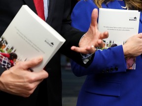 Copies of the 2022 federal budget documents are seen in the hands of Finance Minister and Deputy Prime Minister Chrystia Freeland and Prime Minister Justin Trudeau as they speak with members of the media before the release of the federal budget, on Parliament Hill, in Ottawa, Thursday, April 7, 2022.