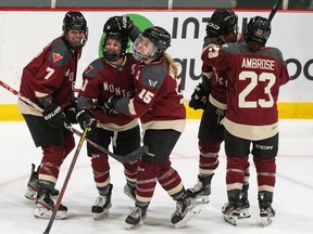 Montreal's Kristin O'Neill (43) celebrates her game-winning goal over Minnesota with teammates during third-period PWHL hockey action in Montreal on Thursday, April 18, 2024.