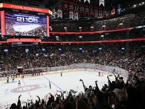 Fans cheer on as the attendance number is displayed on the big screen during third period PWHL hockey action between Toronto and Montreal at the Bell Centre in Montreal, Saturday, April 20, 2024.