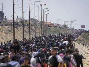 Displaced Palestinians try to walk back from central Gaza Strip to northern Gaza Strip , Sunday, April 14, 2024.