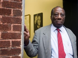 A man stands in a doorway.