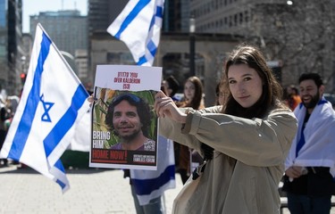 A woman holds up a photo during a vigil by students at McGill University on Tuesday, April 9, 2024 demanding the release of Israeli hostages held by Hamas in Gaza.