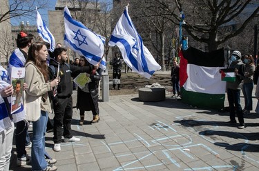 Students stand in front of a pro-Palestinian counter-protest at the end of a vigil at McGill University on Tuesday, April 9, 2024 to demand the release of the Hamas-held Israeli hostages held by Hamas in Gaza.