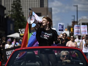 Parade grand marshal Fae Johnstone calls out chants through a megaphone during the Capital Pride Parade in Ottawa on Sunday, Aug. 27, 2023.