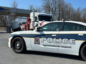 A photo provided by Longueuil police shows a police car at a gas station on Grande Allée in Brossard.