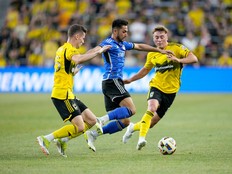 CF Montréal forward Matías Cóccaro works against Columbus Crew's Sean Zawadzki and Aidan Morris during a soccer match.