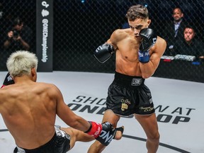 Canadian Jonathan Di Bella is shown in action Oct. 21, 2022, against China's (The Fighting Rooster) Zhang Peimian (blond hair) at One 162: Zhang vs. Di Bella in Kuala Lumpur, Malaysia. Di Bella won by unanimous decision to claim the vacant One Strawweight kickboxing world title.