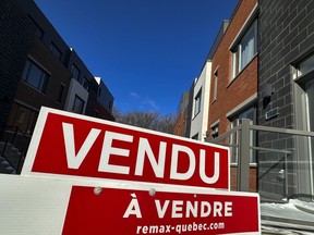 A "sold" sign is shown in a new housing development in Lasalle, a borough of Montreal, Monday, Feb. 19, 2024. The Quebec Professional Association of Real Estate Brokers says Montreal-area home sales rose 14.2 per cent in March compared with the same month last year.