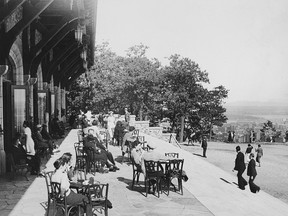 A black and white photo shows people gathered at a lookout spot atop Mount Royal.