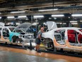 Cars pass along the assembly line at the Stellantis plant in Brampton, Ont., Friday, July 21, 2023.