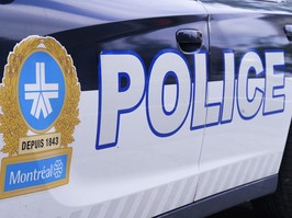 The side of a police car is seen in full frame, with a montreal police logo and the word POLICE written in huge capital letters.