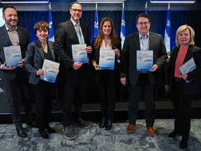 Minister of the French Language Jean-Francois Roberge, third right, poses with colleagues, from left, Minister of Culture and Communications Mathieu Lacombe, Immigration Minister Christine Frechette, Minister for Higher Education Pascale Dery, Education Minister Bernard Drainville and Minister of International Relations and La Francophonie Martine Biron following a press conference concerning the Plan for the French language in Montreal, Sunday, April 28, 2024.