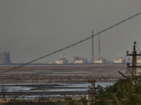 The Zaporizhzhia Nuclear Power Plant, Europe's largest, is seen in the background of the shallow Kakhovka Reservoir after the dam collapse, in Energodar, Russian-occupied Ukraine, Tuesday, June 27, 2023.