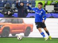 CF Montréal striker Matias Coccaro has the ball near his feet and he eyes the field.