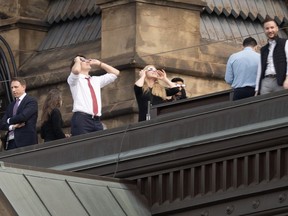 Prime Minister Justin Trudeau takes in the solar eclipse from the roof of the Office of the Prime Minister and Privy Council building, Monday, April 8, 2024 in Ottawa.