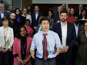 Prime Minister Justin Trudeau is flanked by Minister of Housing Sean Fraser, right, and Treasury Board president Anita Anand, left, during a press conference in Oakville, Ont., on Wednesday, April 24, 2024.